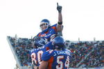 BOISE, ID - NOVEMBER 20:  Running back Jon Helmandollar #33 of Boise State is hoisted up by teammates Andy Weldon #80 and Jeff Cavender #54 after scoring a touchdown in the fourth quarter against Louisiana Tech at Bronco Stadium on November 20, 2004 in Boise, Idaho. Boise State defeated Louisiana Tech 55-14. (Photo by Jeff Gross/Getty Images)