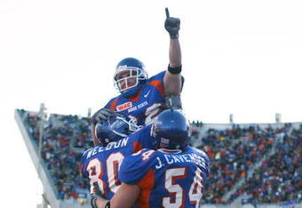 BOISE, ID - NOVEMBER 20:  Running back Jon Helmandollar #33 of Boise State is hoisted up by teammates Andy Weldon #80 and Jeff Cavender #54 after scoring a touchdown in the fourth quarter against Louisiana Tech at Bronco Stadium on November 20, 2004 in Boise, Idaho. Boise State defeated Louisiana Tech 55-14. (Photo by Jeff Gross/Getty Images)