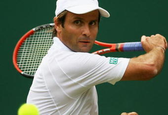 LONDON - JUNE 24:  Fabrice Santoro of France plays a backhand during the men's singles round one match against Andy Murray of United Kingdom on day two of the Wimbledon Lawn Tennis Championships at the All England Lawn Tennis and Croquet Club on June 24, 2008 in London, England.  (Photo by Julian Finney/Getty Images)