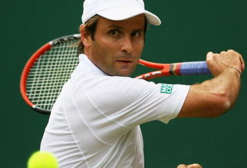 LONDON - JUNE 24:  Fabrice Santoro of France plays a backhand during the men's singles round one match against Andy Murray of United Kingdom on day two of the Wimbledon Lawn Tennis Championships at the All England Lawn Tennis and Croquet Club on June 24, 2008 in London, England.  (Photo by Julian Finney/Getty Images)