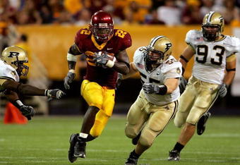 MINNEAPOLIS, MN - SEPTEMBER 24: Laurence Maroney #22 of Minnesota carries the ball against Cliff Avril #85, Brandon Villareal #55 and Rob Ninkovich #93 of Purdue in the third quarter on September 24, 2005 at the Hubert H. Humphrey Metrodome in Minneapolis, Minnesota.  (Photo by Matthew Stockman/Getty Images)