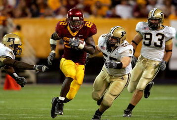 MINNEAPOLIS, MN - SEPTEMBER 24: Laurence Maroney #22 of Minnesota carries the ball against Cliff Avril #85, Brandon Villareal #55 and Rob Ninkovich #93 of Purdue in the third quarter on September 24, 2005 at the Hubert H. Humphrey Metrodome in Minneapolis, Minnesota.  (Photo by Matthew Stockman/Getty Images)