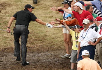 FARMINGDALE, NY - JUNE 21:  Phil Mickelson walks past fans to the 18th tee during the continuation of the third round of the 109th U.S. Open on the Black Course at Bethpage State Park on June 21, 2009 in Farmingdale, New York.  (Photo by Ross Kinnaird/Getty Images)