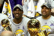 ORLANDO, FL - JUNE 14:  Kobe Bryant #24 of the Los Angeles Lakers holds the Bill Russell MVP trophy and Derek Fisher #2 of the Lakers holds the Larry O'Brien trophy after the Lakers defeated the Orlando Magic 99-86 in Game Five of the 2009 NBA Finals on June 14, 2009 at Amway Arena in Orlando, Florida.  NOTE TO USER:  User expressly acknowledges and agrees that, by downloading and or using this photograph, User is consenting to the terms and conditions of the Getty Images License Agreement.  (Photo by Elsa/Getty Images)