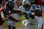 CHARLOTTE, NC - SEPTEMBER 28:  Running back DeAngelo Williams #34 of the Carolina Panthers stiff arms Safety Lawyer Malloy #36 of the Atlanta Falcons in the third quarter of the game at Bank of America Stadium on September 28, 2008 in Charlotte, North Carolina. The Carolina Panthers won the game 24-9. (Photo by Steve Dykes/Getty Images)