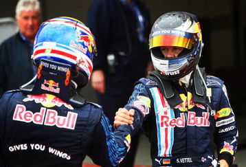 NORTHAMPTON, UNITED KINGDOM - JUNE 21:  Sebastian Vettel (R) of Germany and Red Bull Racing celebrates with second placed Mark Webber (L) of Australia and Red Bull Racing in parc ferme after winning the British Formula One Grand Prix at Silverstone on June 21, 2009 in Northampton, England.  (Photo by Clive Mason/Getty Images)
