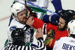 CHICAGO - MAY 05:  Linesman Derek Arnell attempts to seperate Andrew Ladd #16 of the Chicago Blackhawks and Daniel Sedin #22 of the Vancouver Canucks during the first period of Game Three of the Western Conference Semifinal Round of the 2009 Stanley Cup Playoffs on May 5, 2009 at the United Center in Chicago, Illinois  (Photo by Jonathan Daniel/Getty Images)