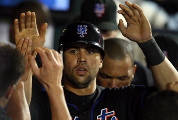 NEW YORK - JUNE 19:  Carlos Beltran #15 of the New York Mets celebrates in the dugout after scoring in the eigth inning against the Tampa Bay Rays on June 19, 2009 at Citi Field in the Flushing neighborhood of the Queens borough of New York City.  (Photo by Jim McIsaac/Getty Images)