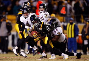 PITTSBURGH - JANUARY 18:  Edgar Jones #84 and  Tom Zbikowski #28 of the Baltimore Ravens tackle Santonio Holmes #10 of the Pittsburgh Steelers on a punt return during the AFC Championship game on January 18, 2009 at Heinz Field in Pittsburgh, Pennsylvania.  (Photo by Streeter Lecka/Getty Images)