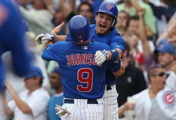 CHICAGO - JUNE 18: Ryan Theriot #2 of the Chicago Cubs hugs teammate Reed Johnson #9 after Johnson scored the winning run in the bottom of the 9th inning on a single by Alfonso Soriano to beat the Chicago White Sox on June 18, 2009 at Wrigley Field in Chicago, Illinois. The Cubs defeated the White Sox 6-5. (Photo by Jonathan Daniel/Getty Images)