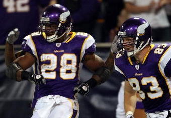 MINNEAPOLIS - JANUARY 4:  Adrian Peterson #28 of the Minnesota Vikings celebrates his touchdown with teammate Jeff Dugan #83 in the first half against the Philadelphia Eagles during the NFC Wild Card playoff game on January 4, 2009 at the Hubert H. Humphrey Metrodome in Minneapolis, Minnesota. (Photo by Elsa/Getty Images)