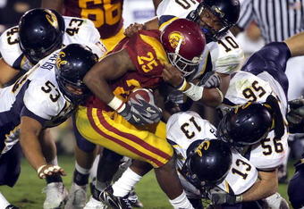 LOS ANGELES - NOVEMBER 18:  C.J. Gable #25 of the University of Southern California Trojans is tackled by the California Golden Bears defense on November 18, 2006 at Los Angeles Memorial Coliseum in Los Angeles, California.  (Photo by Lisa Blumenfeld/Getty Images)