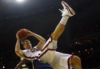 KANSAS CITY, MO - MARCH 21:  Blake Griffin #23 of the Oklahoma Sooners falls on the back of Manny Harris #3 of the Michigan Wolverines during the second round of the NCAA Division I Men's Basketball Tournament at the Sprint Center on March 21, 2009 in Kansas City, Missouri.  (Photo by Jamie Squire/Getty Images)