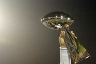 Tom Brady holds the Vince Lombardi Trophy as he stands on the podium after The New England Patriots defeated The Philadelphia Eagles in Super Bowl XXXIX at Alltel Staduim in Jacksonville, Florida.  (Photo by Al Messerschmidt/Getty Images)