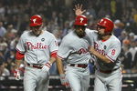NEW YORK - JUNE 11: Raul Ibanez #29 (center) of the Philadelphia Phillies is congratulated on his 3 run home run in the tenth inning by scoring runners Shane Victorino #8 and Chase Utley #26 against the New York Mets on June 11, 2009 at Citi Field in the Flushing neighborhood of the Queens borough of New York City. (Photo by Nick Laham/Getty Images)