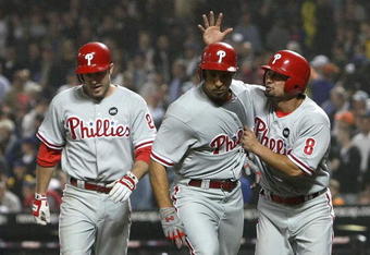 NEW YORK - JUNE 11: Raul Ibanez #29 (center) of the Philadelphia Phillies is congratulated on his 3 run home run in the tenth inning by scoring runners Shane Victorino #8 and Chase Utley #26 against the New York Mets on June 11, 2009 at Citi Field in the Flushing neighborhood of the Queens borough of New York City. (Photo by Nick Laham/Getty Images)