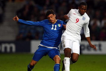 LONDON - MARCH 31:  Daniel Sturridge of England is challenged by Mattia Mustacchio of Italy during the International Friendly match between England U20's and Italy U20's at Loftus Road on March 31, 2009 in London, England.  (Photo by Clive Rose/Getty Images)