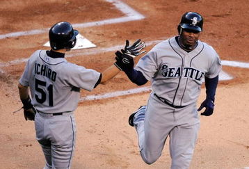 ANAHEIM, CA - APRIL 25:  Ken Griffey Jr. #24 of the Seattle Mariners is congratulated Ichiro Suzuki #51 after they scored on a three-run home run by teammate  Russell Branyan #30 against the Los Angeles Angels of Anaheim during the first inning of the baseball game on April 25, 2009 at Angel Stadium in Anaheim, California.  (Photo by Kevork Djansezian/Getty Images)