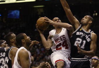 EAST RUTHERFORD, NJ - JUNE 13:  Richard Jefferson #24 of the New Jersey Nets goes up for a shot against Tim Duncan #21 of the San Antonio Spurs during game five of the 2003 NBA Finals on June 13, 2003 at the Continental Airlines Arena in East Rutherford, New Jersey.  The Spurs won 93-83.  NOTE TO USER: User expressly acknowledges and agrees that, by downloading and/or using this Photograph, User is consenting to the terms and conditions of the Getty Images License Agreement.  (Photo by:  Jed Jacobsohn/Getty Images)