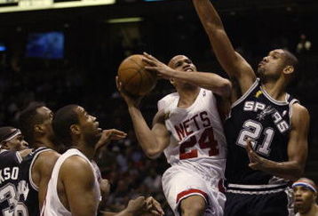 EAST RUTHERFORD, NJ - JUNE 13:  Richard Jefferson #24 of the New Jersey Nets goes up for a shot against Tim Duncan #21 of the San Antonio Spurs during game five of the 2003 NBA Finals on June 13, 2003 at the Continental Airlines Arena in East Rutherford, New Jersey.  The Spurs won 93-83.  NOTE TO USER: User expressly acknowledges and agrees that, by downloading and/or using this Photograph, User is consenting to the terms and conditions of the Getty Images License Agreement.  (Photo by:  Jed Jacobsohn/Getty Images)