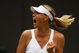 WIMBLEDON, ENGLAND - JUNE 22: Maria Sharapova of Russia celebrates during the women's singles first round match against Viktoriya Kutuzova of Ukraine on Day One of the Wimbledon Lawn Tennis Championships at the All England Lawn Tennis and Croquet Club on June 22, 2009 in London, England. (Photo by Julian Finney/Getty Images)