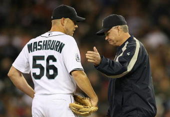 SEATTLE  - SEPTEMBER 16:  Starting pitcher Jarrod Washburn #56 of the Seattle Mariners is removed from the game in the fifth inning by manager John McLaren #8 against the Tampa Bay Devil Rays on September 16, 2007 at Safeco Field in Seattle, Washington. Catcher Jamie Burke #15 is at right. (Photo by Otto Greule Jr/Getty Images)