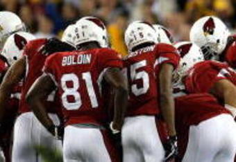 TAMPA, FL - FEBRUARY 01:  Larry Fitzgerald #11, Anquan Boldin #81, Steve Breaston #15 and Kurt Warner #13 of the Arizona Cardinals huddle on offense against the Pittsburgh Steelers defense during Super Bowl XLIII on February 1, 2009 at Raymond James Stadium in Tampa, Florida. The Steelers won 27-23. (Photo by Chris Graythen/Getty Images)