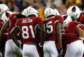 TAMPA, FL - FEBRUARY 01:  Larry Fitzgerald #11, Anquan Boldin #81, Steve Breaston #15 and Kurt Warner #13 of the Arizona Cardinals huddle on offense against the Pittsburgh Steelers defense during Super Bowl XLIII on February 1, 2009 at Raymond James Stadium in Tampa, Florida. The Steelers won 27-23. (Photo by Chris Graythen/Getty Images)