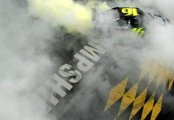 LOUDON, NH - SEPTEMBER 14:  Greg Biffle, driver of the #16 Dish Network Turbo HD Ford, does a burnout following his victory in the NASCAR Sprint Cup Series Sylvania 300 at New Hampshire Motor Speedway on September 14, 2008 in Loudon, New Hampshire.  (Photo by Chris Trotman/Getty Images for NASCAR)