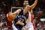 MIAMI - DECEMBER 16:  Mike Miller #33 of the Memphis Grizzlies drives to the basket against Jason Kapono #24 of the Miami Heat during the game at American Airlines Arena on December 16, 2006 in Miami, Florida. The Miami Heat won 98-90. NOTE TO USER: User expressly acknowledges and agrees that, by downloading and or using this photograph, User is consenting to the terms and conditions of the Getty Images License Agreement. (Photo by Doug Benc/Getty Images)