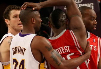 LOS ANGELES, CA - MAY 17:  Kobe Bryant #24 of the Los Angeles Lakers and Ron Artest #96 of the Houston Rockets get twisted up in the second quarter of Game Seven of the Western Conference Semifinals during the 2009 NBA Playoffs at Staples Center on May 17, 2009 in Los Angeles, California. NOTE TO USER: User expressly acknowledges and agrees that, by downloading and or using this photograph, User is consenting to the terms and conditions of the Getty Images License Agreement.  (Photo by Stephen Dunn/Getty Images)