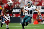 GLENDALE, AZ - JANUARY 18:  Wide receiver Kevin Curtis #80 of the Philadelphia Eagles runs after making a catch as he runs by safety Adrian Wilson #24 of the Arizona Cardinals during the NFC championship game on January 18, 2009 at University of Phoenix Stadium in Glendale, Arizona.  (Photo by Jamie Squire/Getty Images)