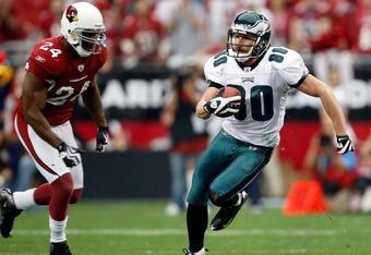 GLENDALE, AZ - JANUARY 18:  Wide receiver Kevin Curtis #80 of the Philadelphia Eagles runs after making a catch as he runs by safety Adrian Wilson #24 of the Arizona Cardinals during the NFC championship game on January 18, 2009 at University of Phoenix Stadium in Glendale, Arizona.  (Photo by Jamie Squire/Getty Images)