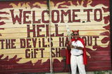 CAYMAN ISLANDS - AUGUST 6:  Laurie 'Ivan' Farrington is pictured dressed in a devil costume holding the Queen's Baton on August 6, 2005 in the village of Hell, West Bay, Cayman Islands. The baton arrives in Australia on January 24, 2006. (Photo by prpix.com.au via Getty Images)               