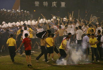 CHONGQING, CHINA - JULY 2: (CHINA OUT) Anti-riot policemen confront simulated mobs during an anti-terror drill themed 'To Welcome Olympic Games,To Ensure the Security' at Datianwan Stadium on July 2, 2008 in Chongqing Municipality, China. China has launched a series of anti-terror drills at the national level to ensure security for the upcoming Olympics in Beijing. (Photo by China Photos/Getty Images)