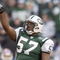 EAST RUTHERFORD, NJ - NOVEMBER 24:  Linebacker Mo Lewis #57 of the New York Jets celebrates after a play against the Buffalo Bills during the NFL game on November 24, 2002 at Giant Stadium in East Rutherford, New Jersey.  The Jets defeated the Bills 31-13.  (Photo by Ezra Shaw/Getty Images)