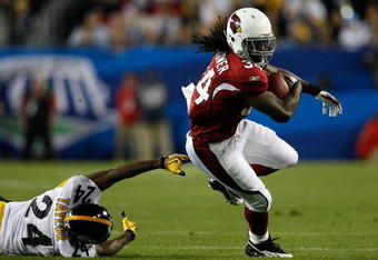 TAMPA, FL - FEBRUARY 01:  Tim Hightower #34 of the Arizona Cardinals runs the ball against Ike Taylor #24 of the Pittsburgh Steelers during Super Bowl XLIII on February 1, 2009 at Raymond James Stadium in Tampa, Florida.  (Photo by Chris Graythen/Getty Images)