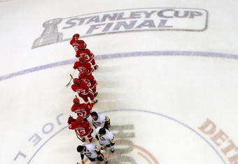 DETROIT - JUNE 12:  Nicklas Lidstrom #5 of the Detroit Red Wings waits to shake hands with captain Sidney Crosby #87 of the Pittsburgh Penguins after Game Seven of the 2009 NHL Stanley Cup Finals at Joe Louis Arena on June 12, 2009 in Detroit, Michigan. The Penguins defeated the Red Wings 2-1 in the seventh game to win the Stanley Cup Finals series 4 games to 3. (Photo by Harry How/Getty Images)