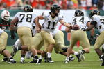 MIAMI - OCTOBER 25:  Quarterback Riley Skinner #11 of the Wake Forest Demon Decons looks to hand the ball off while taking on the Miami Hurricanes at Dolphin Stadium on October 25, 2008 in Miami, Florida. Miami defeated Wake Forest 16-10.  (Photo by Doug Benc/Getty Images)