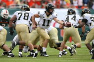 MIAMI - OCTOBER 25:  Quarterback Riley Skinner #11 of the Wake Forest Demon Decons looks to hand the ball off while taking on the Miami Hurricanes at Dolphin Stadium on October 25, 2008 in Miami, Florida. Miami defeated Wake Forest 16-10.  (Photo by Doug Benc/Getty Images)