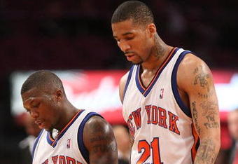 NEW YORK - MARCH 20:  Nate Robinson #4 of the New York Knicks walks from the court with teammate Wilson Chandler #21 against the Sacramento Kingson March 20, 2009 at Madison Square Garden in New York City. NOTE TO USER: User expressly acknowledges and agrees that, by downloading and or using this photograph, User is consenting to the terms and conditions of the Getty Images License Agreement.  (Photo by Nick Laham/Getty Images)