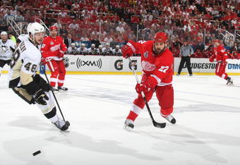 DETROIT - JUNE 12: Brett Lebda #22 of the Detroit Red Wings passes the puck against Tyler Kennedy #48 of the Pittsburgh Penguins during Game Seven of the 2009 NHL Stanley Cup Finals at Joe Louis Arena on June 12, 2009 in Detroit, Michigan. (Photo by: Bruce Bennett/Getty Images)