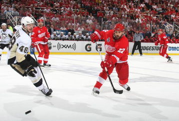 DETROIT - JUNE 12: Brett Lebda #22 of the Detroit Red Wings passes the puck against Tyler Kennedy #48 of the Pittsburgh Penguins during Game Seven of the 2009 NHL Stanley Cup Finals at Joe Louis Arena on June 12, 2009 in Detroit, Michigan. (Photo by: Bruce Bennett/Getty Images)