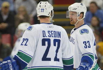 DETROIT - JANUARY 17:  The Sedin brothers Daniel #22 and Henrik #33 of the Vancouver Canucks chat prior to a faceoff in a game against the Detroit Red Wings on January 17, 2008 at the Joe Louis Arena in Detroit, Michigan. The Wings defeated the Canucks 3-2 in a shootout. (Photo by Claus Andersen/Getty Images)