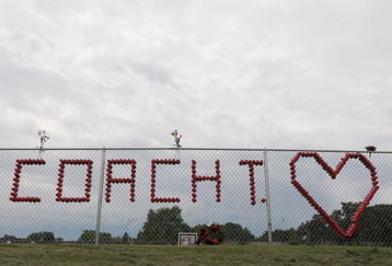 PARKERSBURG, IA - JUNE 24: Students built a makeshift memorial for Aplington-Parkersburg Football coach Ed Thomas at the practice field near where he was shot and killed by a former player in the morning hours of June 24, 2009 in Parkersburg, Iowa.  Thomas had been a coach at the school for 34 years. A 24-year-old suspect has been arrested.  (Photo by David Greedy/Getty Images)