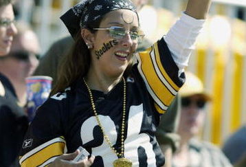 PITTSBURGH - SEPTEMBER 29:  A Pittsburgh Steelers fan cheers during the game on September 29, 2002 against the Cleveland Browns at Heinz Field in Pittsburgh, Pennsylvania. The Steelers kicked an overtime field goal, thus winning the game, 16-13. (Photo by Ezra Shaw/Getty Images)