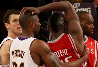 LOS ANGELES, CA - MAY 17:  Kobe Bryant #24 of the Los Angeles Lakers and Ron Artest #96 of the Houston Rockets get twisted up in the second quarter of Game Seven of the Western Conference Semifinals during the 2009 NBA Playoffs at Staples Center on May 17, 2009 in Los Angeles, California. NOTE TO USER: User expressly acknowledges and agrees that, by downloading and or using this photograph, User is consenting to the terms and conditions of the Getty Images License Agreement.  (Photo by Stephen Dunn/Getty Images)