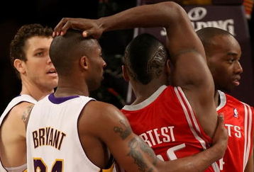 LOS ANGELES, CA - MAY 17:  Kobe Bryant #24 of the Los Angeles Lakers and Ron Artest #96 of the Houston Rockets get twisted up in the second quarter of Game Seven of the Western Conference Semifinals during the 2009 NBA Playoffs at Staples Center on May 17, 2009 in Los Angeles, California. NOTE TO USER: User expressly acknowledges and agrees that, by downloading and or using this photograph, User is consenting to the terms and conditions of the Getty Images License Agreement.  (Photo by Stephen Dunn/Getty Images)
