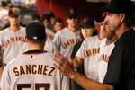 PHOENIX - JUNE 11:  Starting pitcher Jonathan Sanchez #57 of the San Francisco Giants is greeted by Randy Johnson (R) and teammates after being removed from the major league baseball game against the Arizona Diamondbacks at Chase Field on June 11, 2009 in Phoenix, Arizona.  The Diamondbacks defeated the Giants 2-1. (Photo by Christian Petersen/Getty Images)