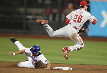 NEW YORK - JUNE 10:  Chase Utley #26 of the Philadelphia Phillies turns a double play as Alex Cora #3 of The New York Mets slides in during their game on June 10, 2009 at Citi Field in the Flushing neighborhood of the Queens borough of New York City.  (Photo by Al Bello/Getty Images)